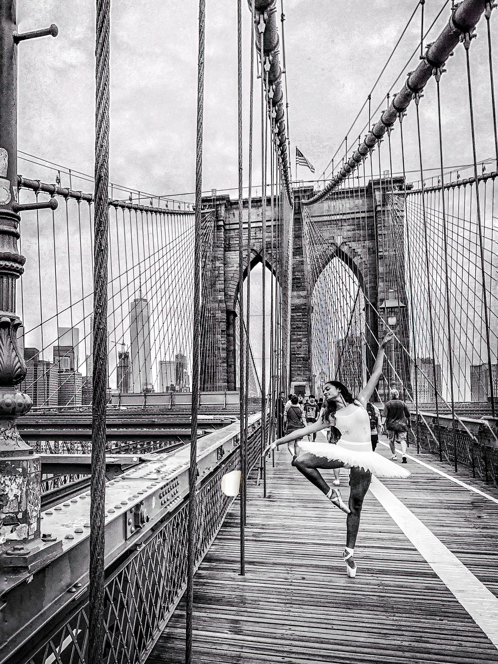 A ballerina en pointe on the Brooklyn Bridge.